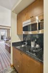 Kitchenette features 2 burner gas stovetop, microwave, dishwasher and hotel size fridge
